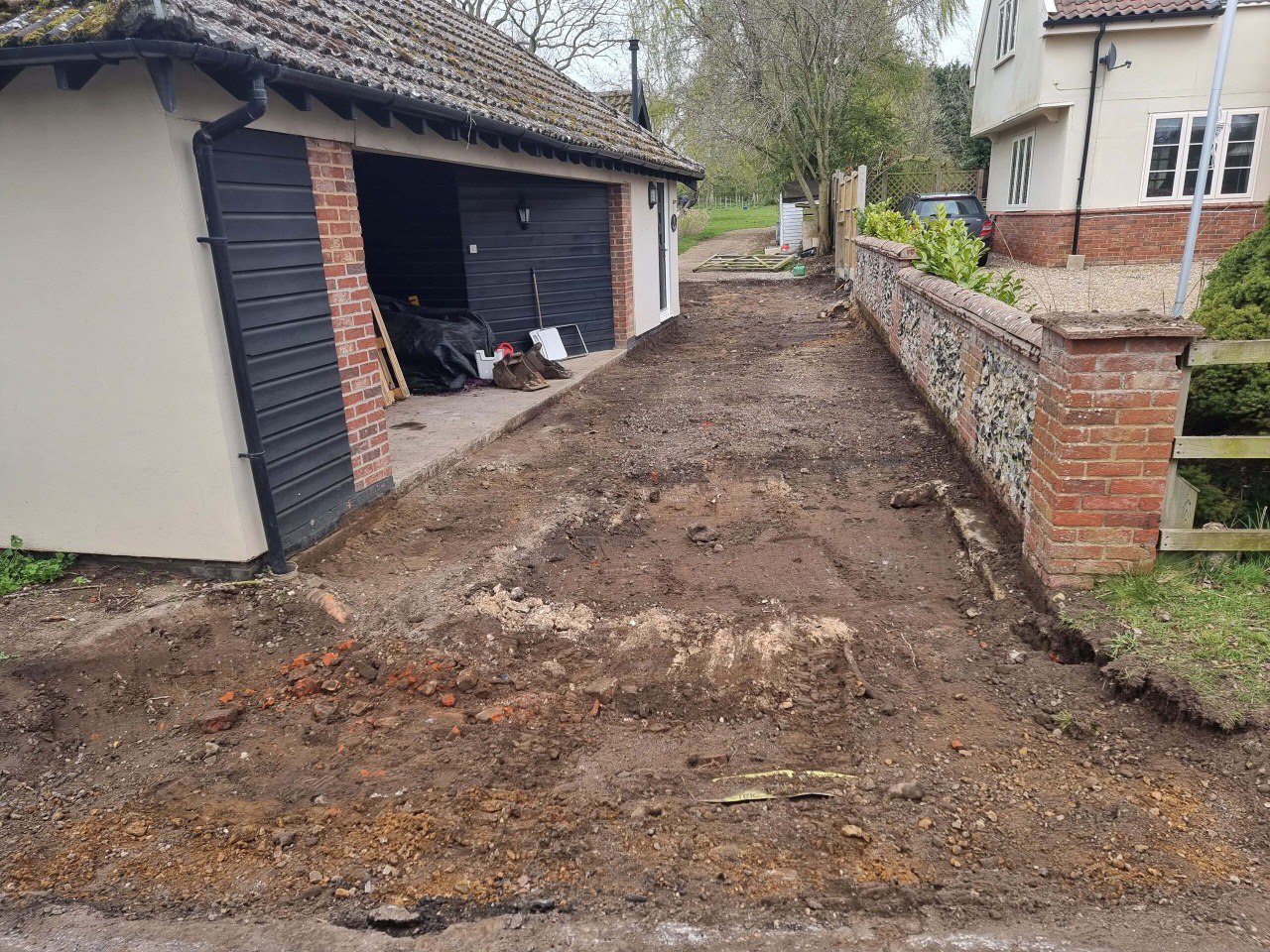 This is a tarmac driveway that is in the process of being dug out and installed by NS Driveways Cranleigh